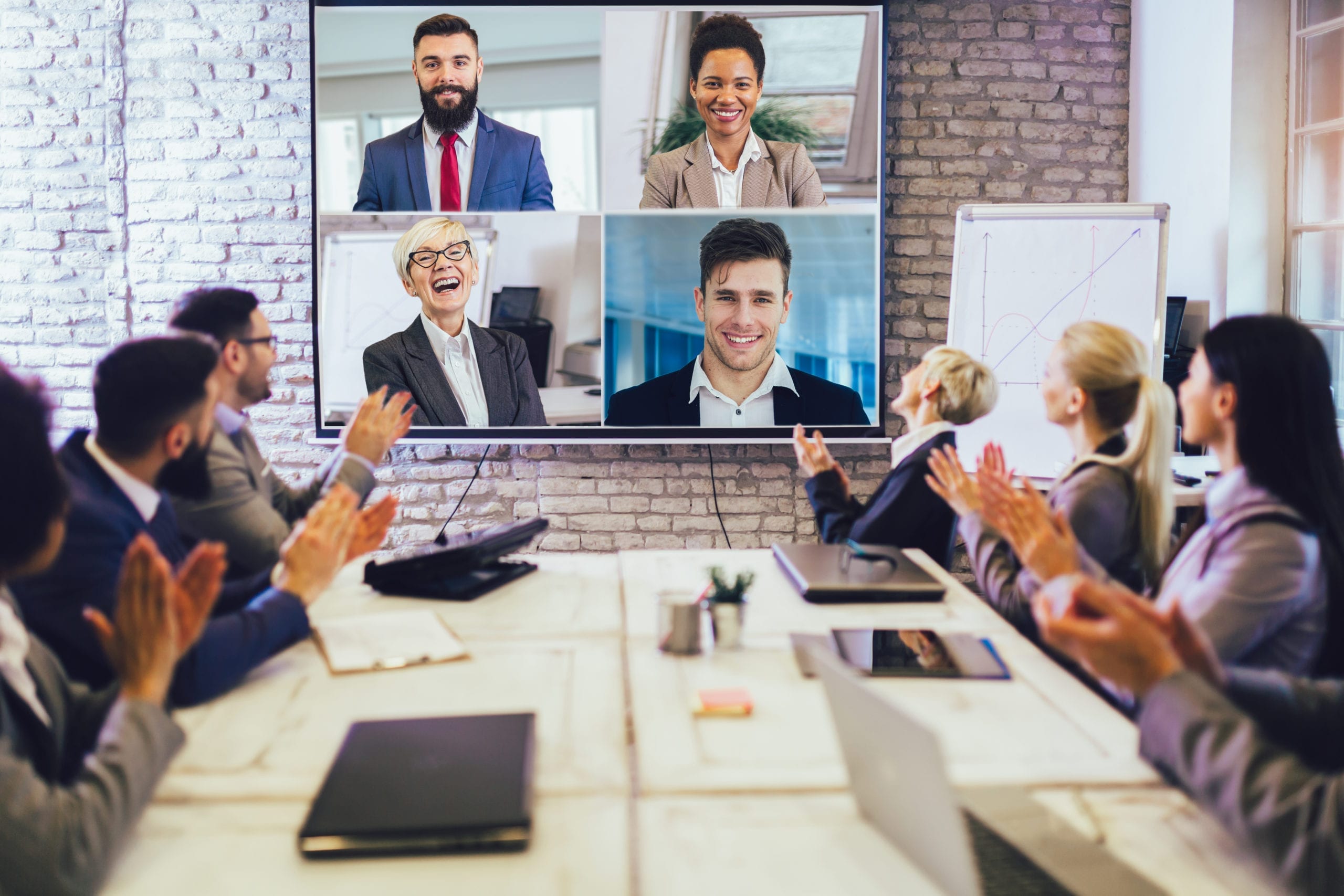 Business people looking at an audio & visual system during a video conference in the conference room