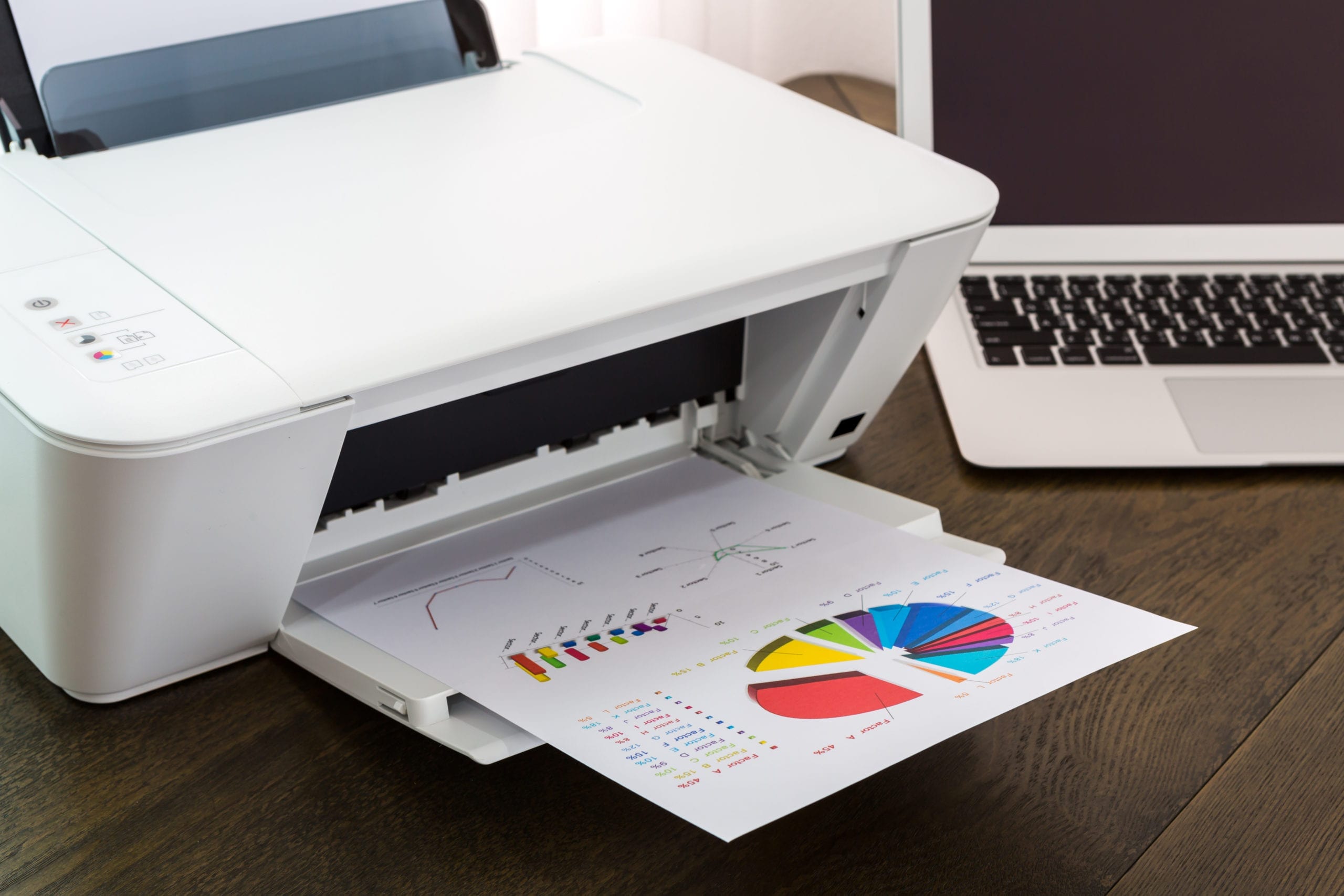 A Printers ability to print out colors is shown with a freshly printed color paper on the printer tray.